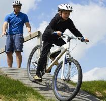 boy riding a mountain bike on a ramp