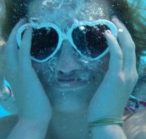 underwater view of girl with sunglasses on